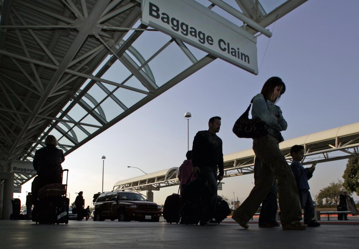 Passengers arrive at Los Angeles/Ontario International Airport, which the city of Ontario has been trying to regain control of for almost three years.