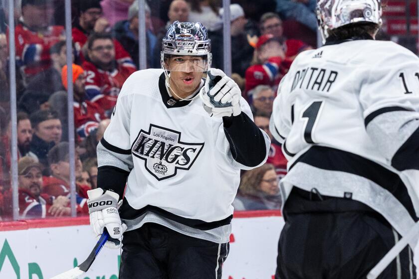 MONTREAL, CANADA - DECEMBER 7: Quinton Byfield #55 of the Los Angeles Kings (left) reacts.