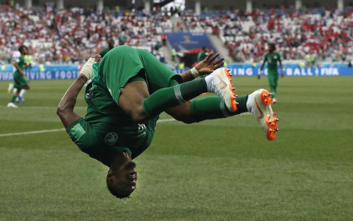 Saudi Arabia's Salem Aldawsari celebrates with a flip after scoring his side's second goal against Egypt on Monday.