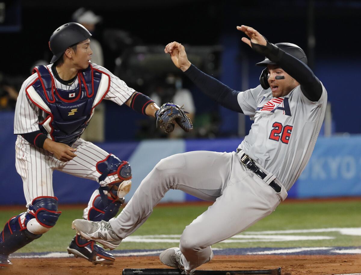 Ryutaro Umeno reaches out to tag Triston Casas at home plate.