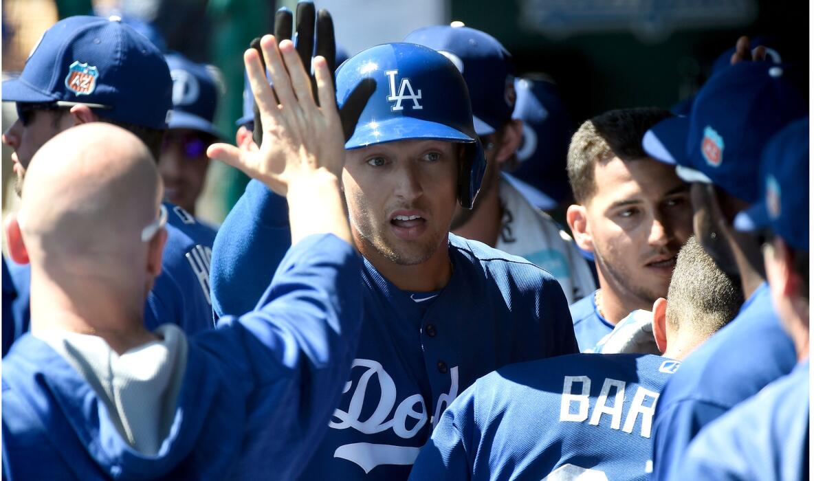 Dodgers outfielder Trayce Thompson is congratulated in the dugout after hitting a three-run home run in the first inning against the Milwaukee Brewers on March 14.