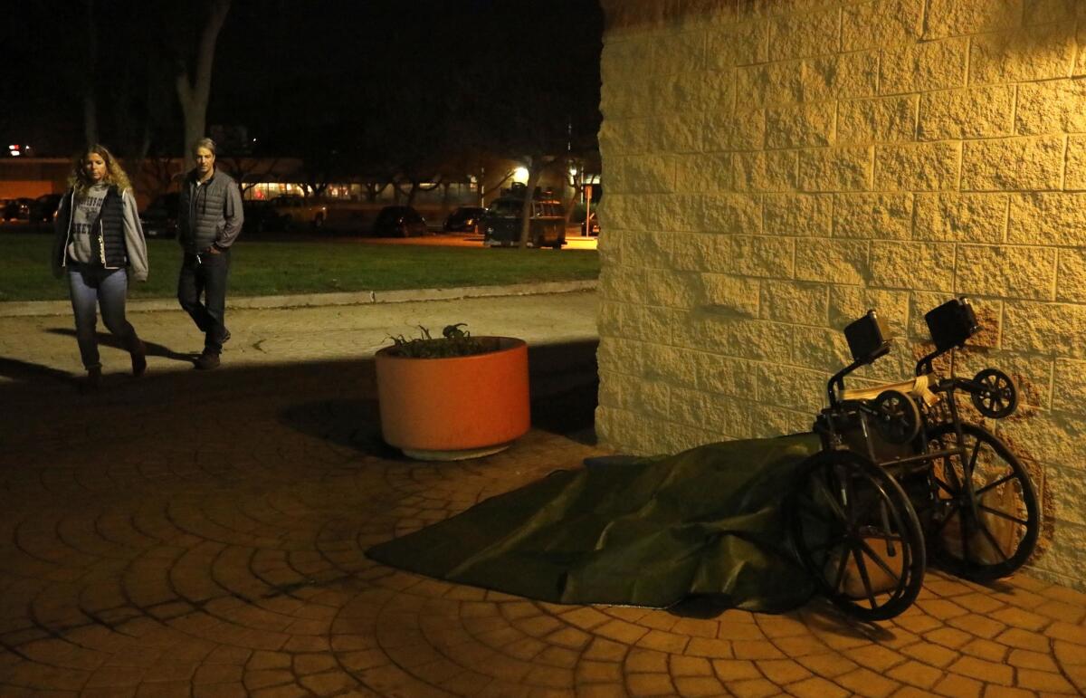 Volunteers Elizabeth Hansell, left, and her husband Jim Kennedy, count a homeless person sleeping in Westchester Recreation Center during the 2018 Greater Los Angeles Homeless Count.