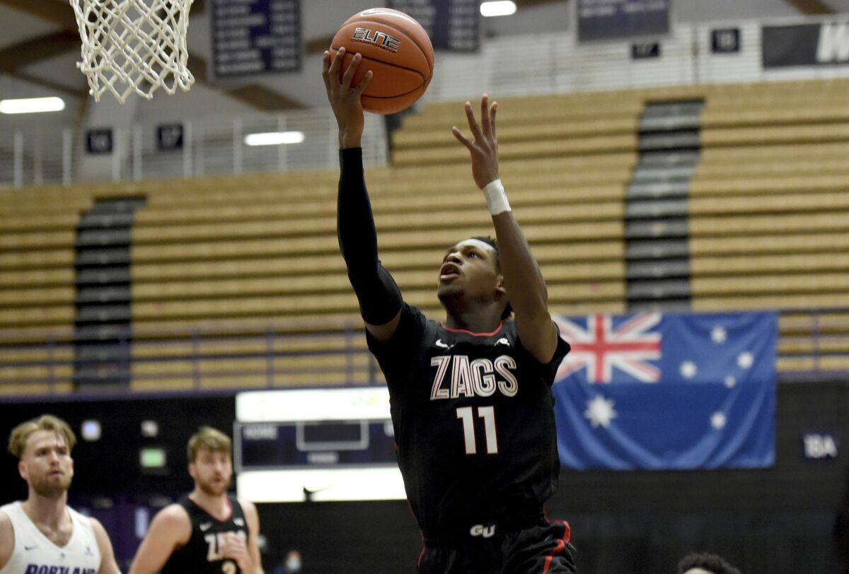 Gonzaga University guard Joel Ayayi, drives to the basket during the first half of an NCAA college basketball game against Portland in Portland, Ore., Saturday, Jan. 9, 2021. (AP Photo/Steve Dykes)