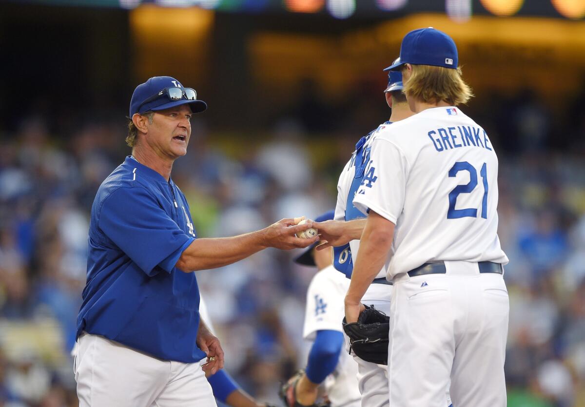 Dodgers Manager Don Mattingly takes starter Zack Greinke out of the game against the Cardinals in the seventh inning Sunday night.