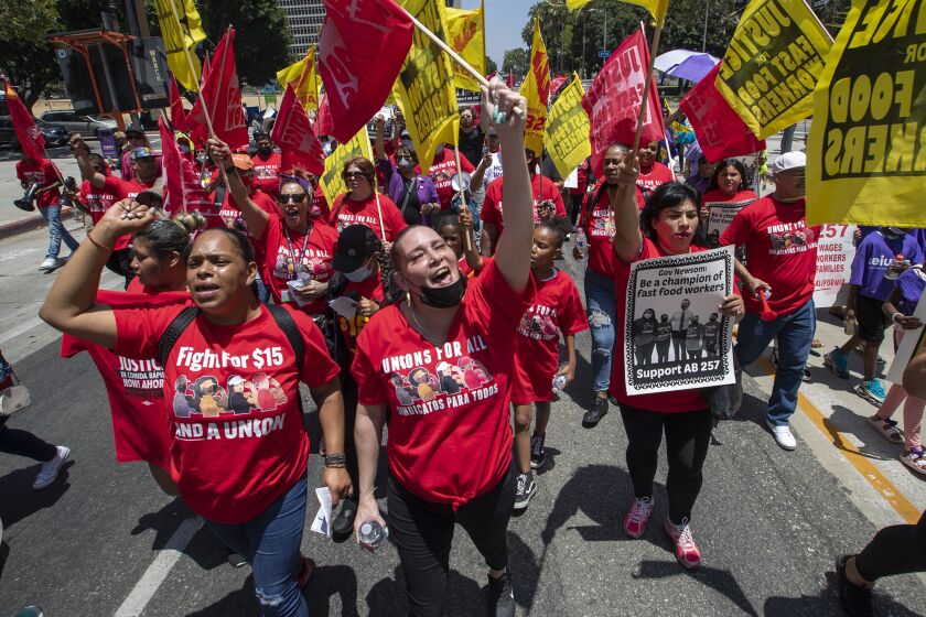 Los Angeles, CA - June 09: Fast-food workers lead a march to the state building on Spring Street after rally at Los Angeles City Hall to protest unsafe working conditions, and to demand a voice on the job through AB 257 Th8ursday June 8 2022 in Los Angeles. (Brian van der Brug/Los Angeles Times)