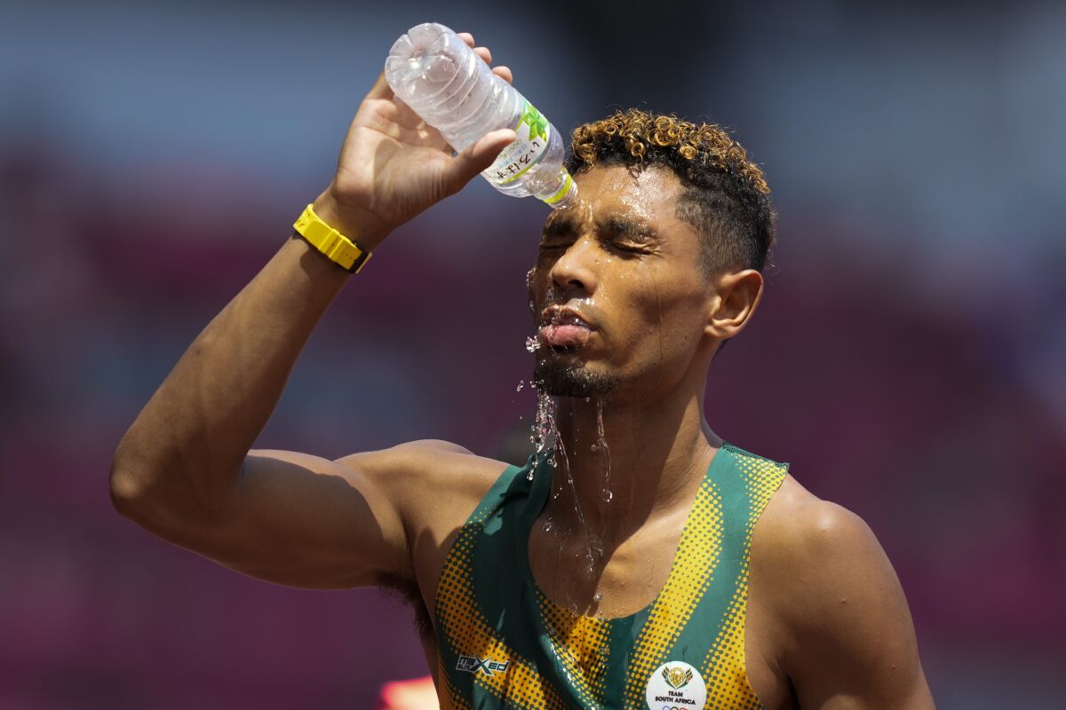 Wayde Van Niekerk, of South Africa, cools off after a heat in the men's 400-meter run at the 2020 Summer Olympics, Sunday, Aug. 1, 2021, in Tokyo. (AP Photo/Martin Meissner)