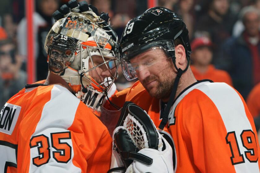 Philadelphia Flyers goalie Steve Mason, left, is congratulated by teammate Scott Hartnell following a 4-1 win over the St. Louis Blues on Saturday. After a disappointing start nearly derailed their season, a more confident Flyers team is working toward the ultimate goal of winning the franchise's first Stanley Cup in nearly four decades.