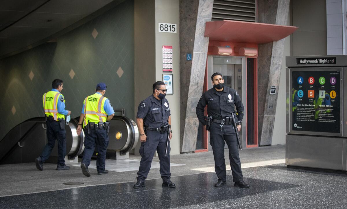 Men in uniforms in front of an entrance that goes underground.