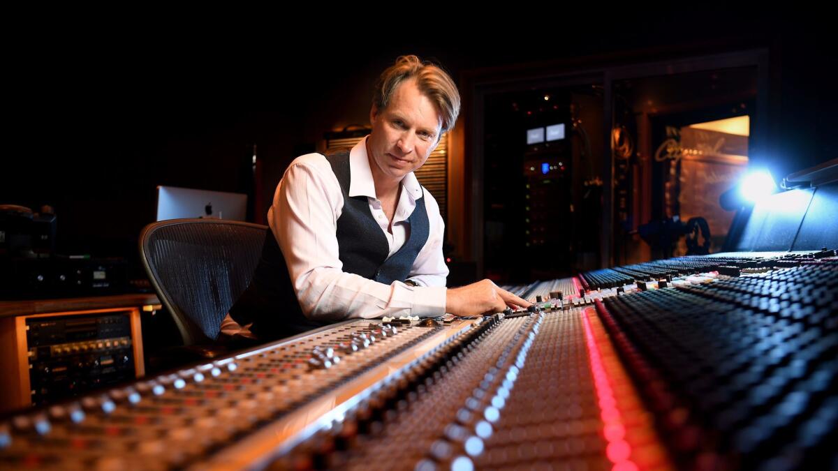 Producer Giles Martin (son of original Beatles producer George Martin) sits at the key board at Capitol Records in Los Angeles.