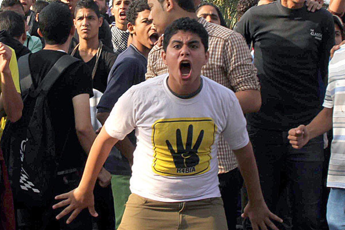 Supporters of ousted Egyptian President Mohammed Morsi protest outside a Cairo courtroom.