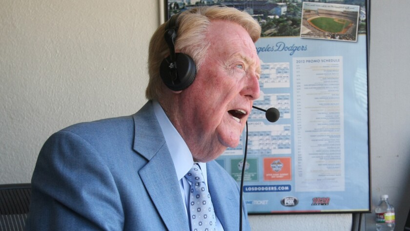Vin Scully prepares to call a game at Dodger Stadium on July 3, 2012. Scully's broadcast career with the Dodgers began in 1950.