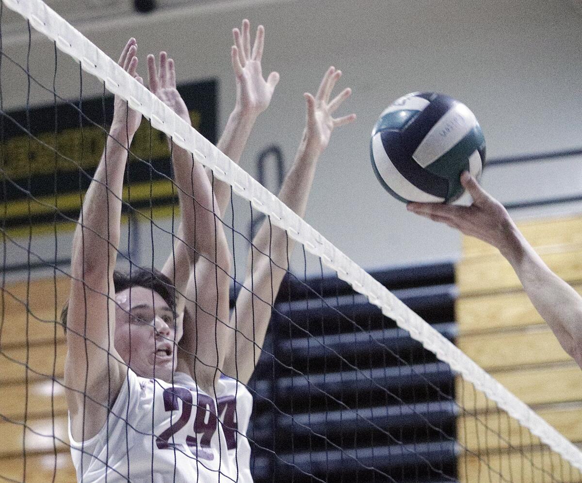 Laguna Beach's Josh Meiswinkel (29) and Milo Zegowitz rise to block a shot in a pool-play match of the Orange County Championships at Edison on Friday in Huntington Beach.