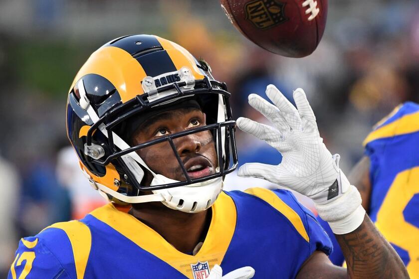 LOS ANGELES, CALIFORNIA DECEMBER 30, 2018-Rams receiver Brandin Cooks plays with a football on the sidelines during a game against the 49ers at the Coliseum. (Wally Skalij/Los Angeles Times)