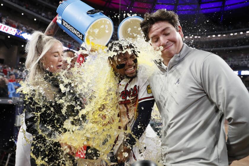 Braves right fielder Ronald Acuña Jr., center, reacts as he gets dunked with Gatorade during an interview after a baseball game against the Chicago Cubs on Wednesday, Sep. 27, 2023, in Atlanta. (Miguel Martinez/Atlanta Journal-Constitution via AP)