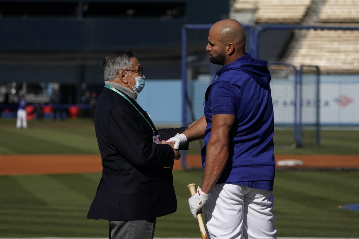 Dodgers Spanish-language broadcaster Jaime Jarrín, left, speaks to Albert Pujols before a playoff game in 2021.