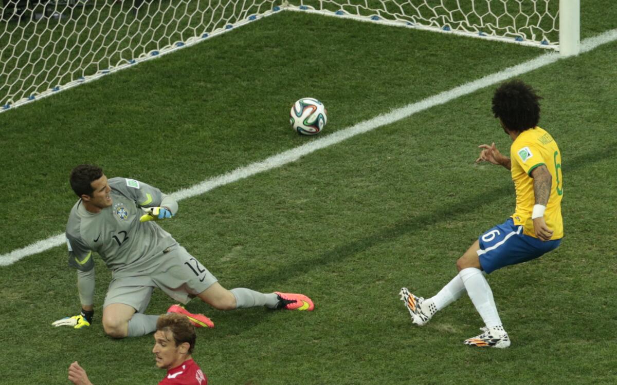 Brazil's Marcelo, right, scores an own goal during the match between Brazil and Croatia.