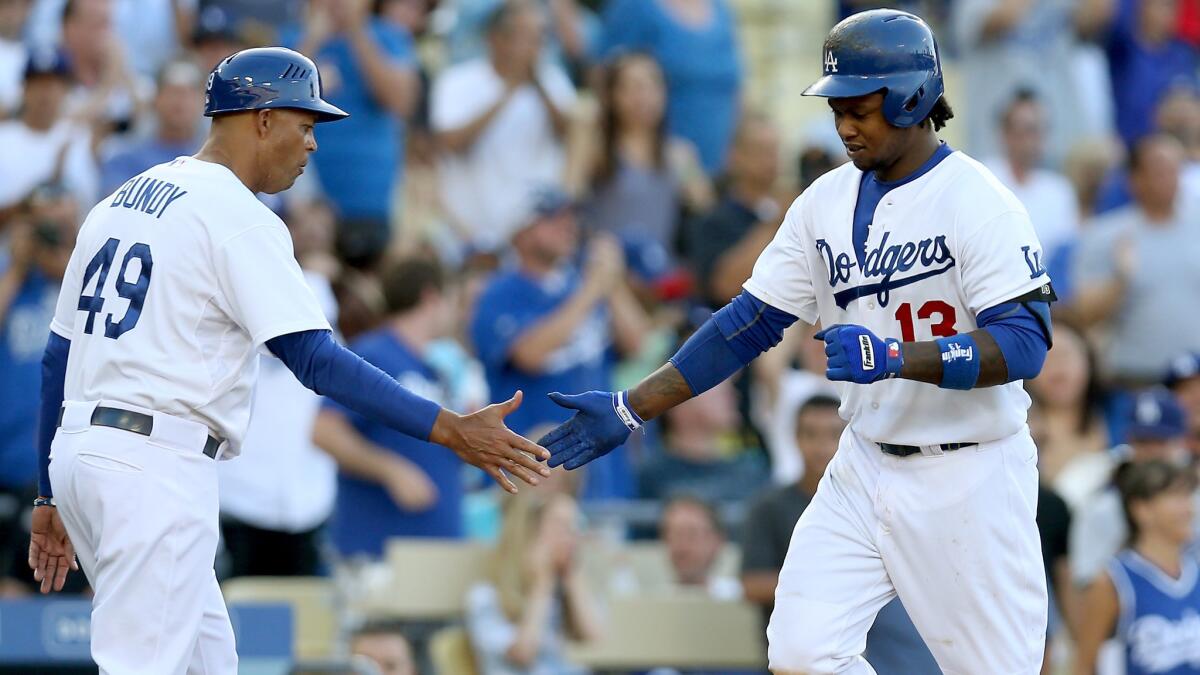 Dodgers shortstop Hanley Ramirez, right, is congratulated by third base coach Lorenzo Bundy after hitting a solo home run during the sixth inning of the Dodgers' 12-2 win over the Pittsburgh Pirates on Saturday.