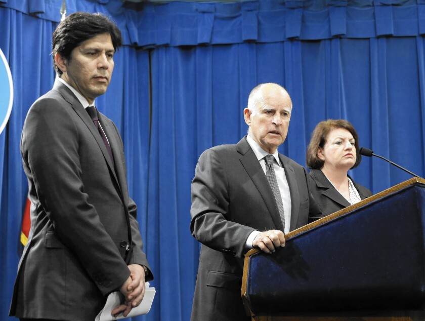 Gov. Jerry Brown, with state Senate leader Kevin de León, left, and Assembly Speaker Toni Atkins, answers a question about the 2015-16 state budget agreement, which includes environmental law exemptions for certain development projects.