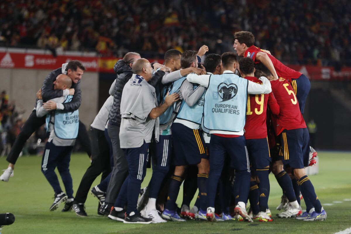 Spain players and team members celebrate after Spain's Alvaro Morata scored the opening goal during the World Cup 2022 group B qualifying soccer match between Spain and Sweden at La Cartuja stadium in Seville, Spain, Sunday, Nov. 14, 2021. (AP Photo/Angel Fernandez)