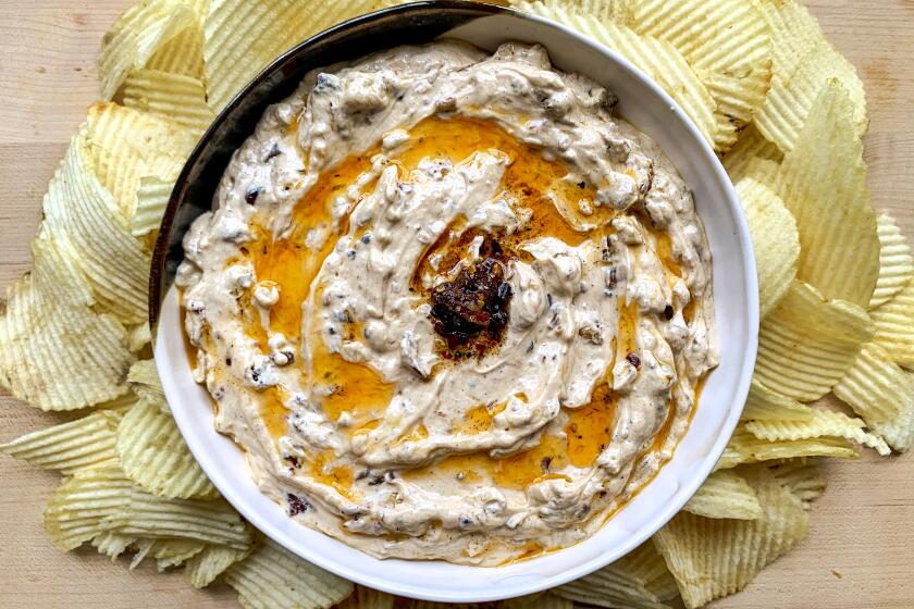 Fried Onion-Chili Crisp Dip: Round bowl with ruffle potato chips.