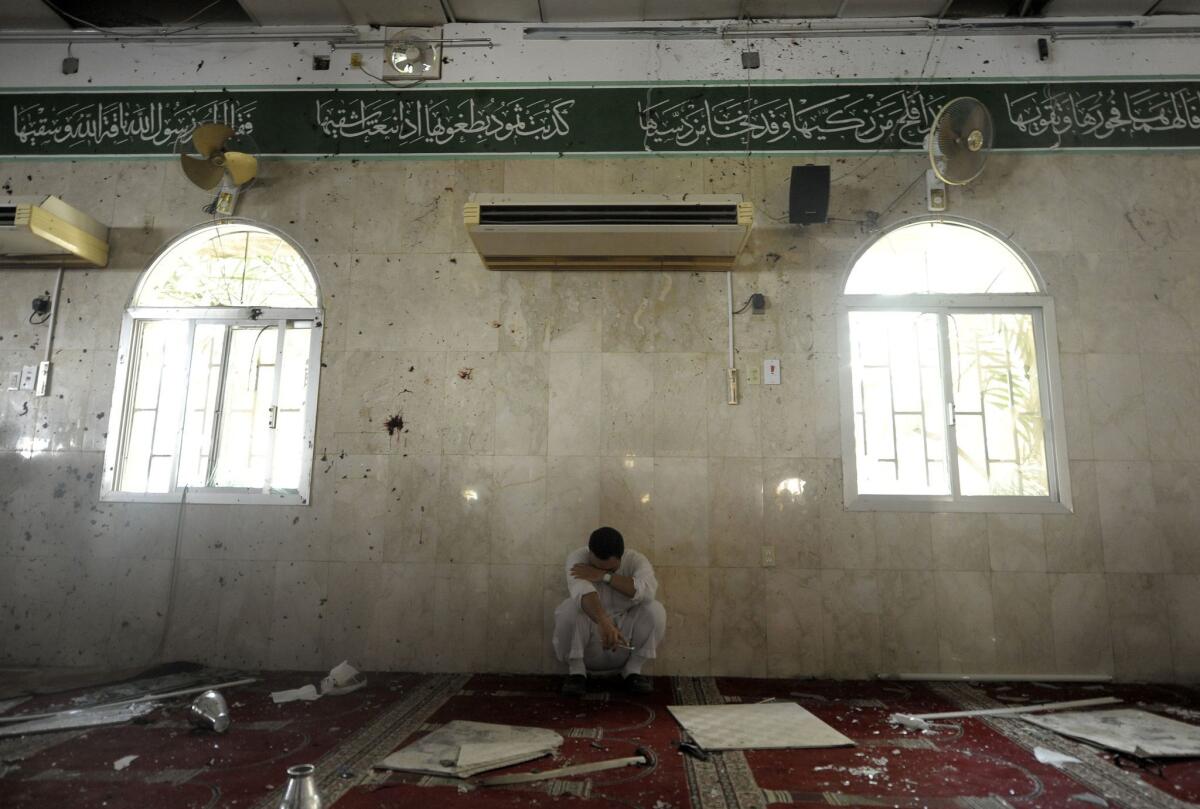 A man sits alone after a bombing at a Shiite mosque in the eastern Saudi town of Qudayh, near the regional center of Qatifi, on May 22.