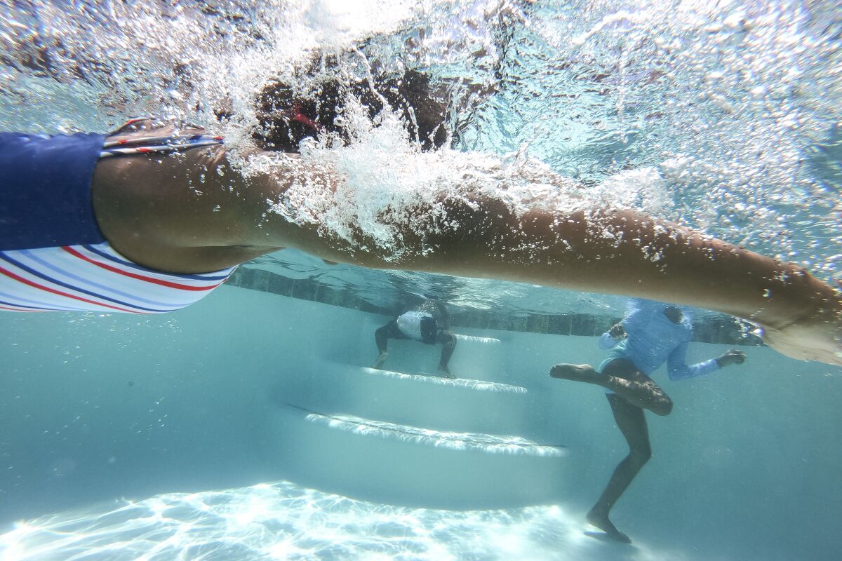 An underwater photo of kids swimming