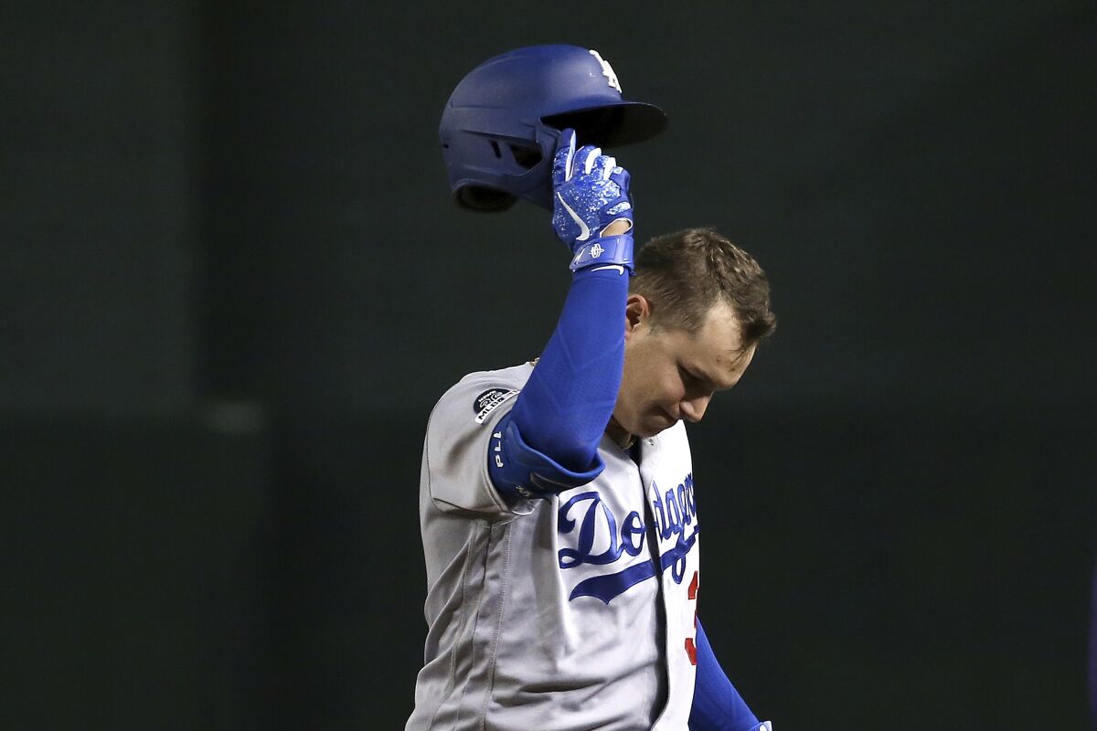 Joc Pederson takes his helmet off after flying out.