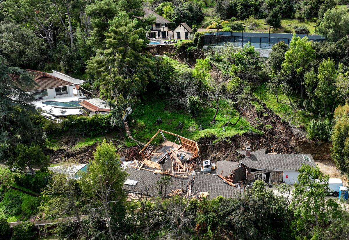 A landslide that started near a home at the top of the image destroyed one 