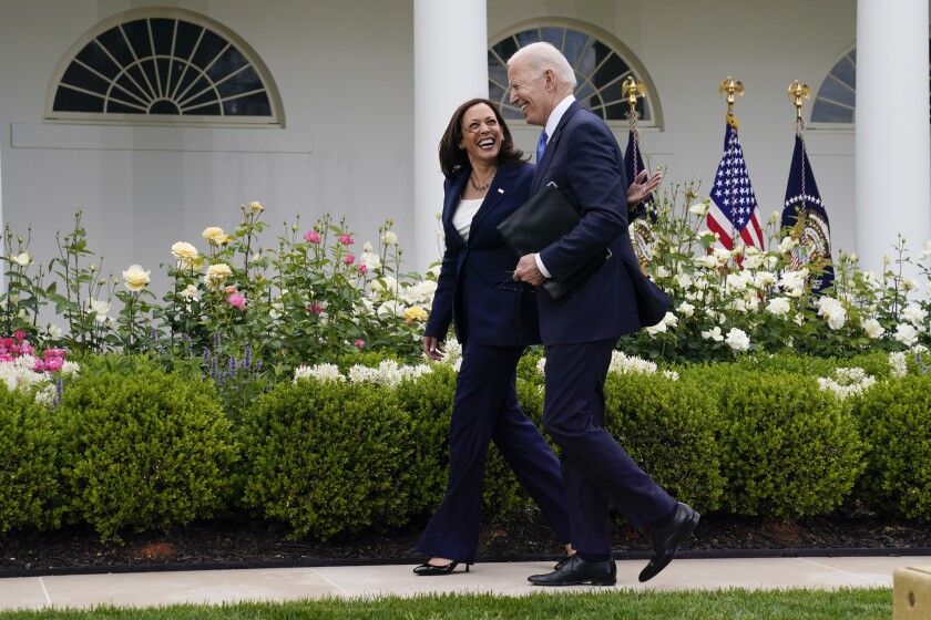 FILE - President Joe Biden walks with Vice President Kamala Harris after speaking on updated guidance on face mask mandates and COVID-19 response, in the Rose Garden of the White House, May 13, 2021, in Washington. Harris is capping off a controversial first year in office, creating history as the first woman of color in her position while fending off criticism and complaints over her focus and agenda. While she’s sought to make the office her own, Harris has struggled at times with the constraints of a global pandemic and the realities of a role focused squarely on promoting the president. (AP Photo/Evan Vucci, File)