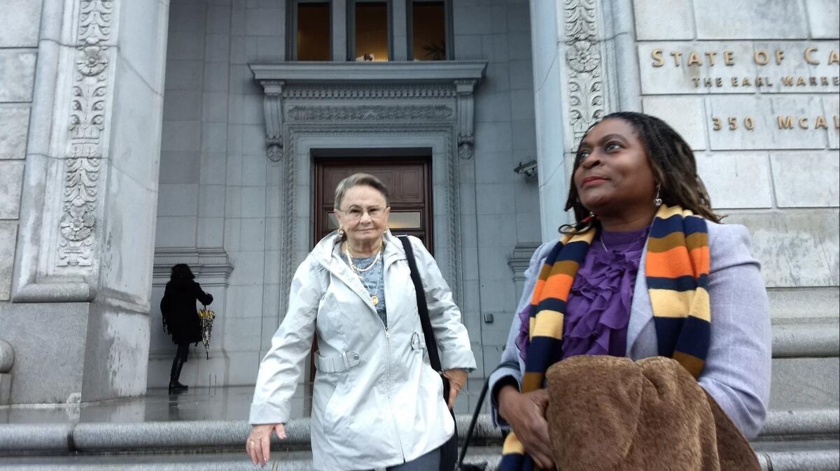 Milena (Sellers) Phillips, right, and Maria Keever are seen Wednesday as they arrive at the office complex in San Francisco where the California Supreme Court was to hear the appeal of a death sentence for the killer of their sons.