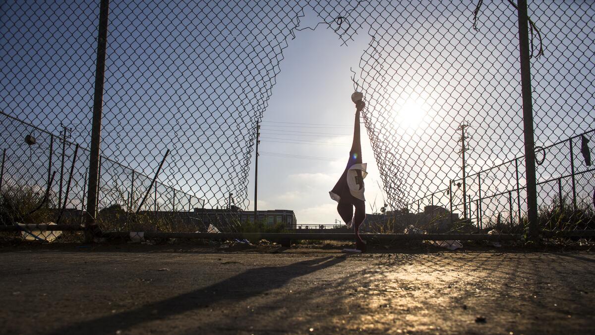 Torn fencing, tattered clothing and garbage are all that remain in the vacant lot in the 8400 block of Vermont near Manchester Avenue.