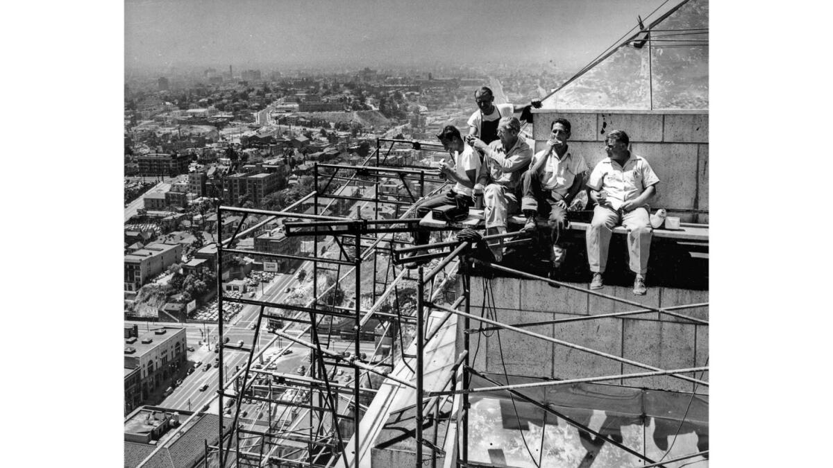 Aug. 16, 1950: Workmen putting stainless steel covering atop Los Angeles City Hall take a lunch break.