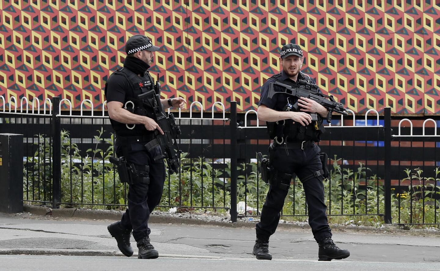 Police patrol May 24, 2017, near Victoria Station in Manchester, England. Armed troops were at vital locations after the official threat level was raised to its highest point following a suicide bombing that killed 22 people.