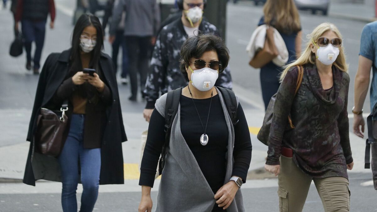 People in San Francisco's financial district wear masks to block the the smoke-filled air.
