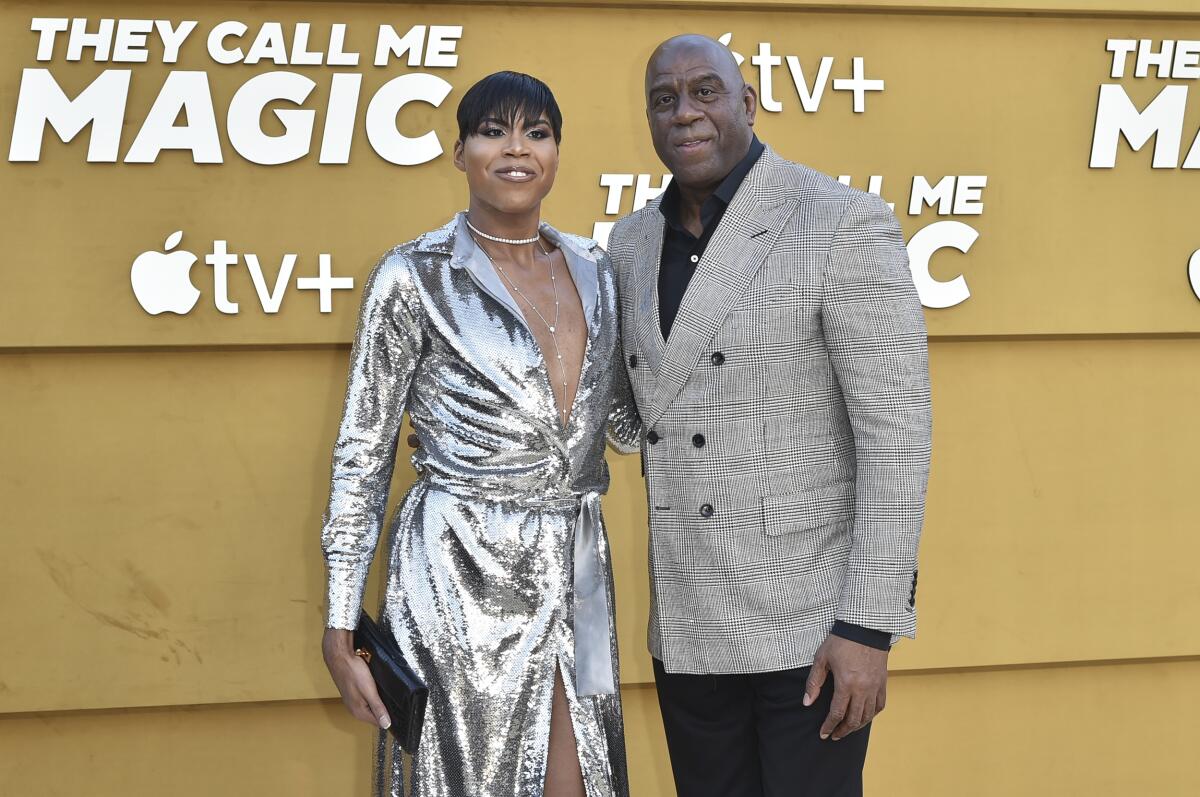 EJ Johnson, left, and father Magic Johnson arrive at a premiere