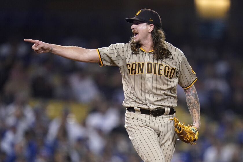 San Diego Padres starting pitcher Mike Clevinger gestures toward the plate after throwing a ball during the third inning in Game 1 of a baseball NL Division Series against the Los Angeles Dodgers Tuesday, Oct. 11, 2022, in Los Angeles. (AP Photo/Ashley Landis)