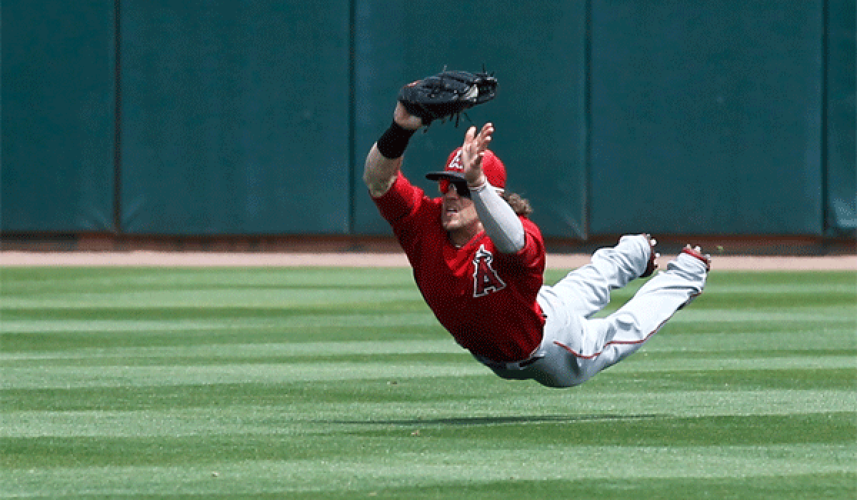 Angels outfielder Collin Cowgill makes a diving catch against Oakland Athletics on March 26.