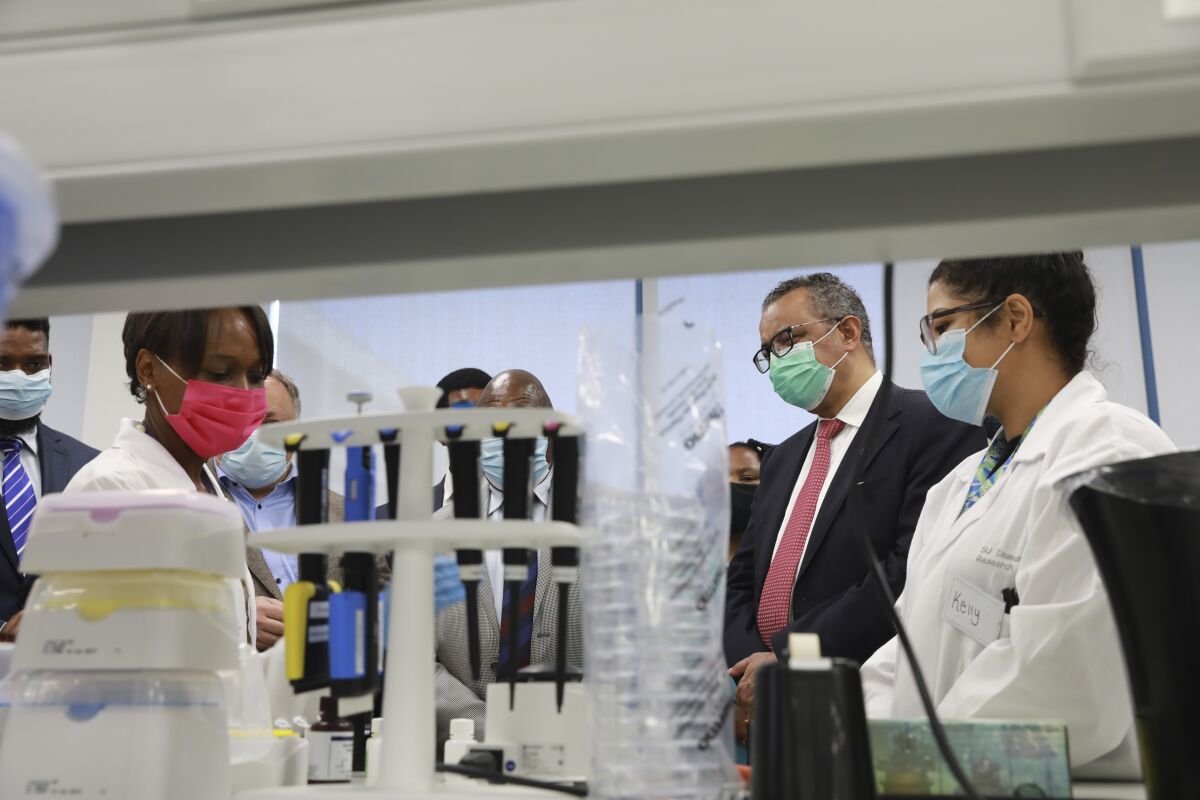 World Health Organisation (WHO) director-general Dr. Tedros Adhanom Ghebreyesus, second from right, visits the Biomedical Research Institute at Stellenbosch University's Faculty of Medicine and Health Sciences at the Tygerberg-campus in Cape Town, South African, Friday, Feb. 11, 2022. South Africa's efforts to produce vaccines are key to helping the African continent become more self-sufficient in inoculations to combat COVID-19 and many other diseases, the visiting chief of the WHO said Friday. (AP Photo/Nardus Engelbrecht)