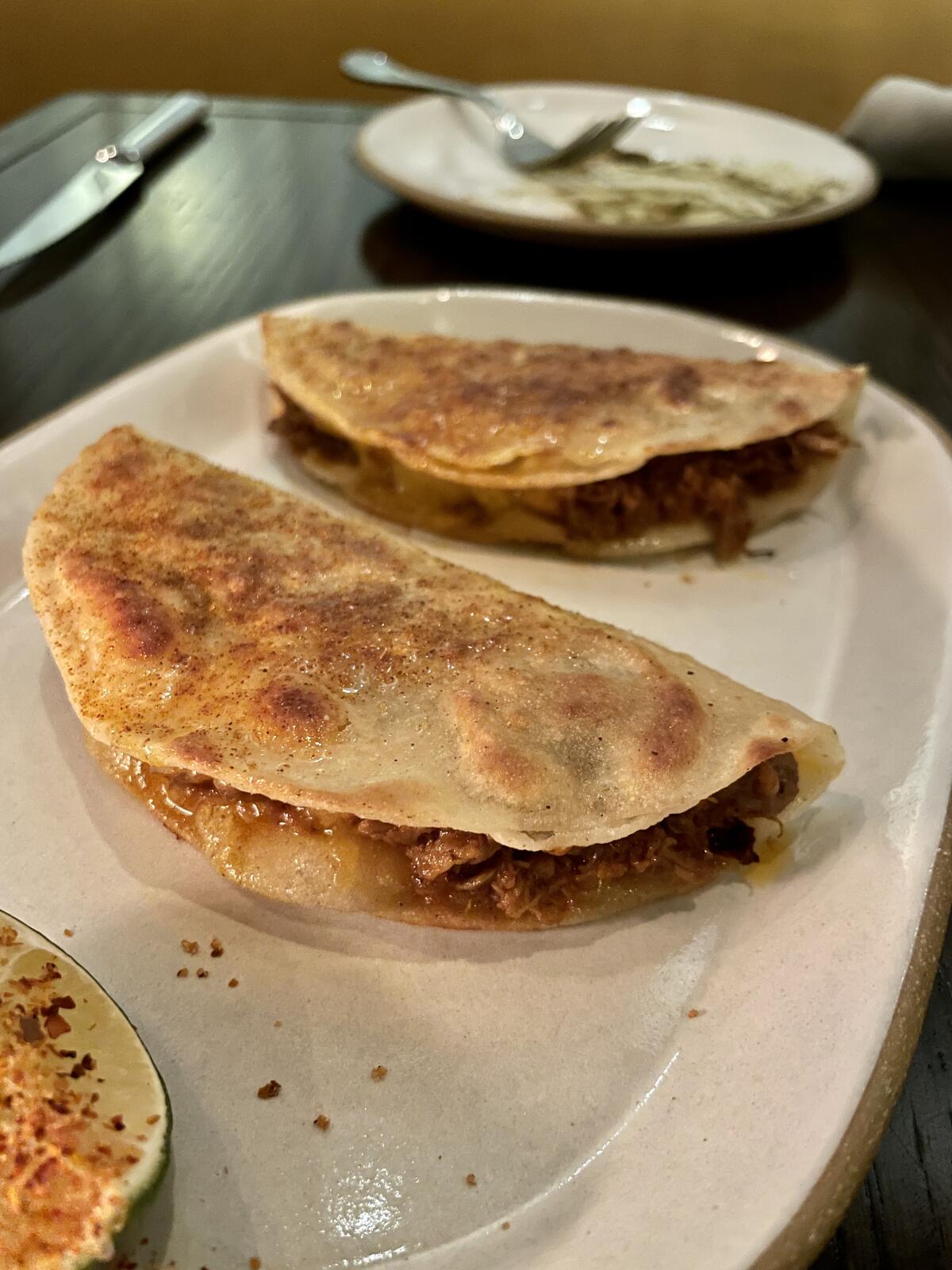 Duck birria tacos from Baar Baar in the center.