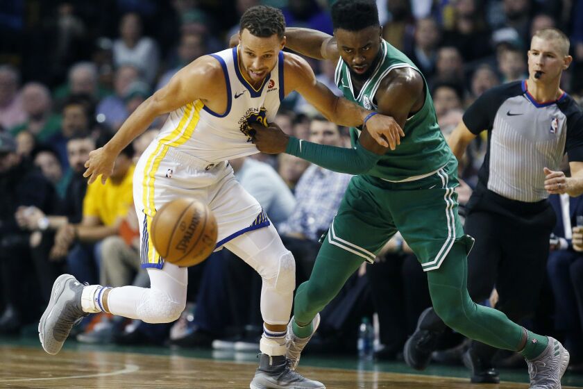 Boston Celtics' Jaylen Brown (7) and Golden State Warriors' Stephen Curry battle for a loose ball during the first quarter of an NBA basketball game in Boston, Thursday, Nov. 16, 2017. (AP Photo/Michael Dwyer)
