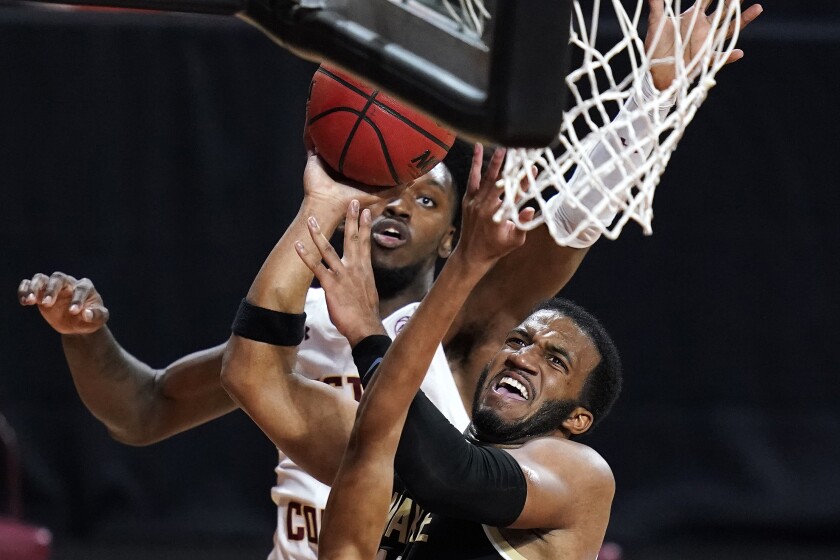 Wake Forest guard Ian DuBose, right, drives to the basket against Boston College forward CJ Felder during the first half of an NCAA basketball game Wednesday, Feb. 10, 2021, in Boston. (AP Photo/Charles Krupa)