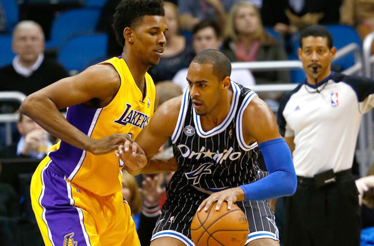 Orlando Magic guard Arron Afflalo, right, tries to drive against Lakers guard Nick Young during a Lakers' 114-105 loss in January.