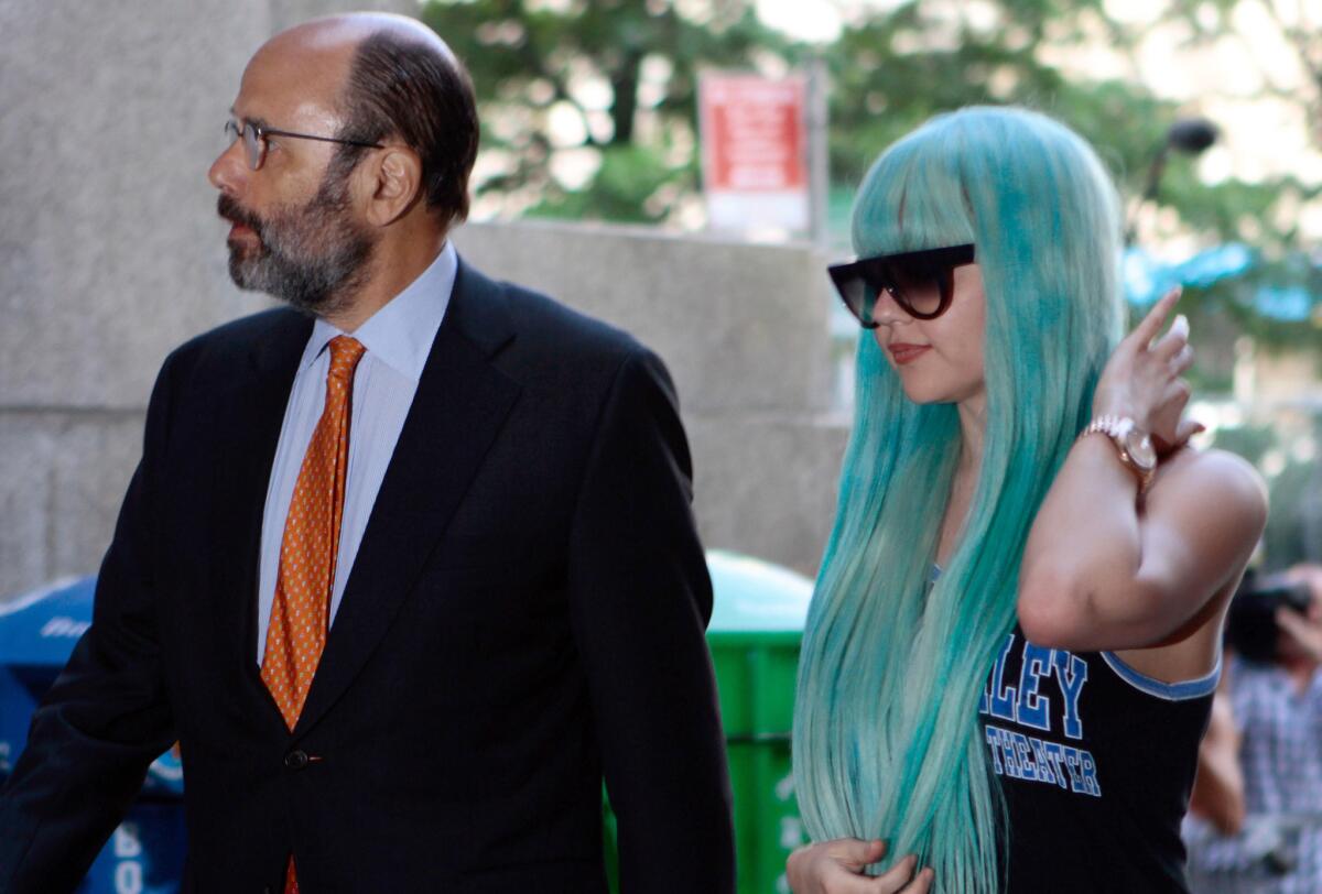 In this July 9, 2013, photo, Amanda Bynes, accompanied by attorney Gerald Shargel, arrives for a court appearance in New York on allegations that she threw a bong out the window of her 36th-floor Manhattan apartment.