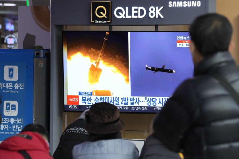 People watch a TV showing file images of North Korea's missile launch during a news program at the Seoul Railway Station in Seoul, South Korea, Tuesday, Jan. 25, 2022. North Korea on Tuesday test-fired two suspected cruise missiles in its fifth round of weapons launches this month, South Korean military officials said, as it displays its military might amid pandemic-related difficulties and a prolonged freeze in nuclear negotiations with the United States. The Korean letters read: "North Korea fired two cruise missiles." (AP Photo/Ahn Young-joon)