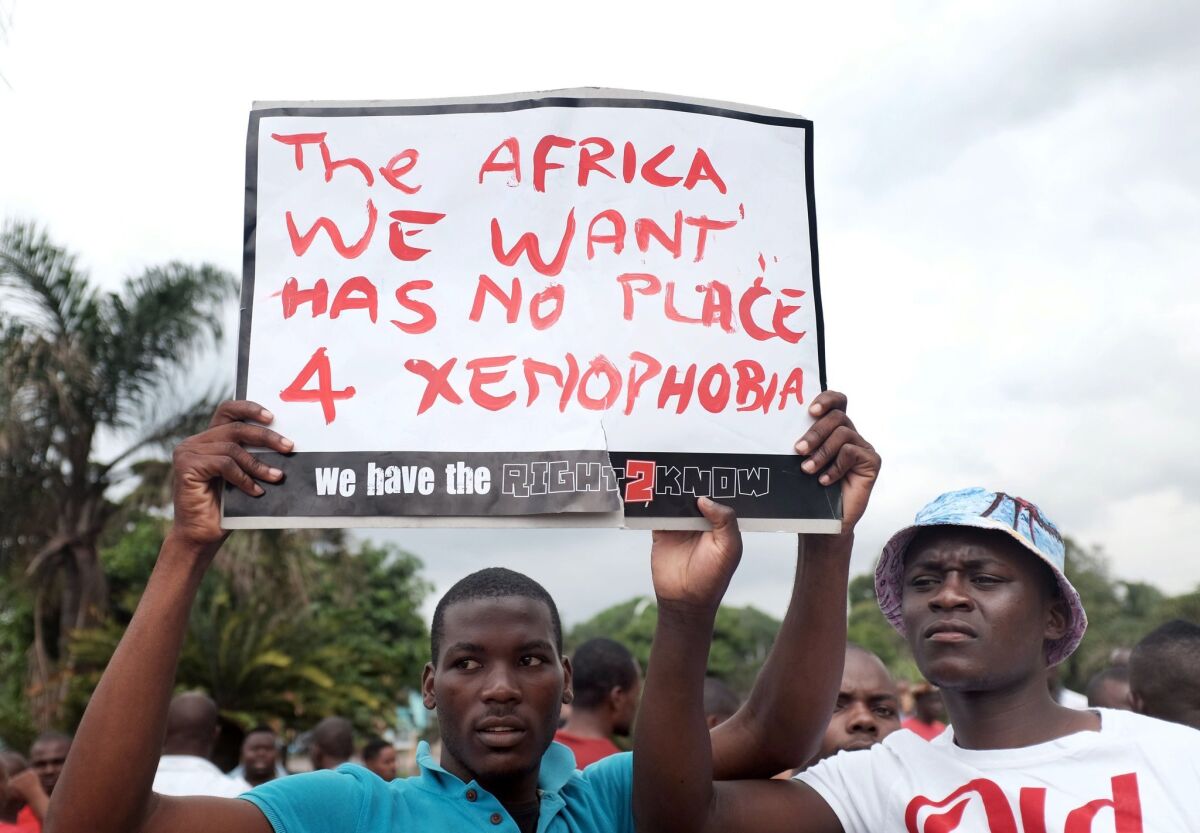 Foreign nationals hold a placard during an anti-xenophobia march outside Durban City Hall in South Africa on April 8.