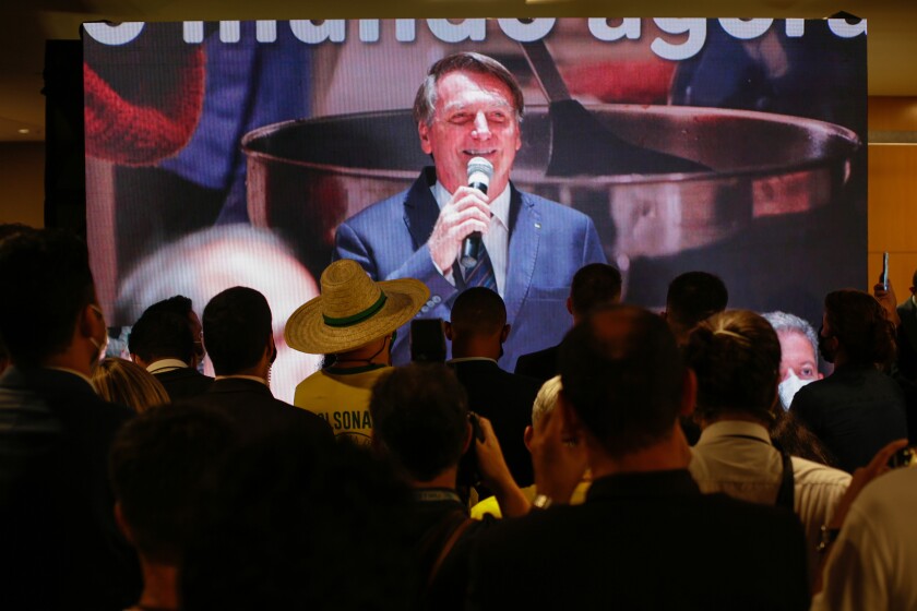 Supporters watch Brazilian President Jair Bolsonaro.