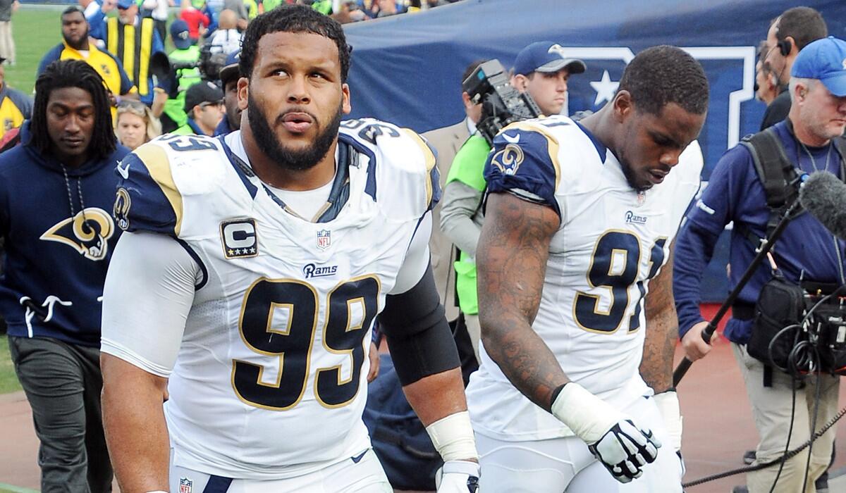 Rams defensive tackles Aaron Donald (99) and Dominique Easley (91) head toward the locker room at halftime during a game against the Atlanta Falcons on Dec. 11.