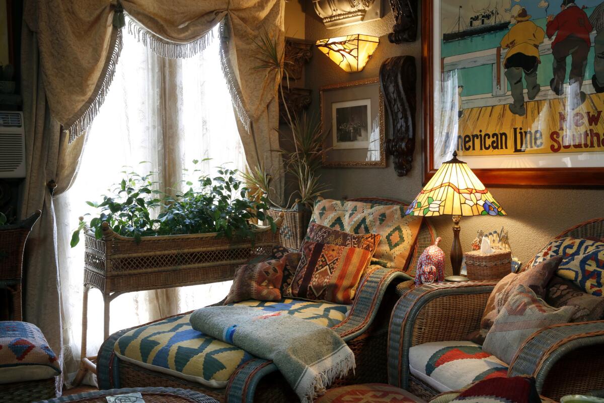 Between the guest room and his library, Iacovelli created a reading room. "This room was formerly the porch to the back unit and just last year I enclosed it," he says. Mid-1980s wicker from Macy's, the first furniture he bought in L.A., is enlivened with Southwestern textiles and kilim cushions.