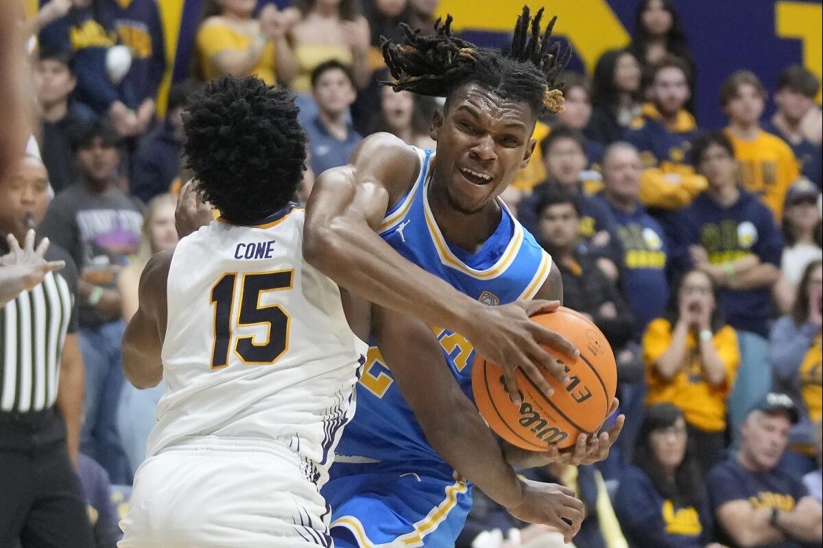 UCLA guard Dylan Andrews is fouled by California guard Jalen Cone while driving to the basket.