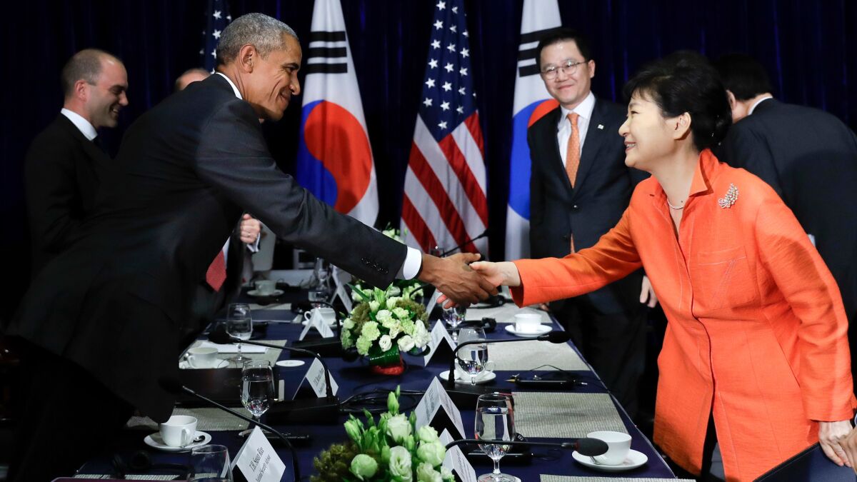 President Obama and South Korean President Park Geun-hye shake hands after meeting in Vientiane, Laos, on Tuesday.
